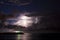 Thunderstorm with lightning at sea over Pier with green port light