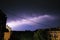Thunderstorm at night over the city. Flashes of lightning and low clouds. Thunder and lightning. Natural element