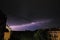 Thunderstorm at night over the city. Flashes of lightning and low clouds. Thunder and lightning. Natural element