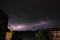 Thunderstorm at night over the city. Flashes of lightning and low clouds. Thunder and lightning. Natural element