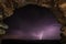 Thunderstorm through old stone arch