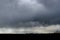 Thunderstorm over the city on a summer evening. Monstrous clouds over industrial buildings. Apocalyptic landscape