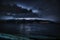 Thunderstorm over the mountains and lake in foreground