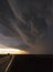 Thunderstorm over road at sunset