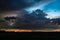 Thundery shower over the plains at dusk