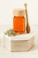 Thyme honey in a jar on a white wooden background