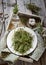 Thyme in vintage plate,napkin and scissors in wooden box.