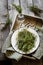 Thyme in vintage plate,napkin and scissors in wooden box.