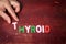 THYROID. Text from colorful alphabet letters on a painted wooden background