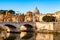 Tiber river streams, Ponte Vittorio Emanuele II bridge, flying seagulls and Rome cityscape view with St. Peter dome on the