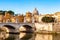 Tiber river streams, Ponte Vittorio Emanuele II bridge, flying seagulls and Rome cityscape view with St. Peter dome on the