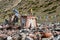 Tibet. Ancient stupa and buddhist prayer stones with mantras and ritual drawings on the trail from the town of Dorchen around moun