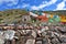 Tibet. Whate stupa and buddhist prayer stones with mantras and ritual drawings on the trail from the town of Dorchen around mount