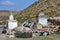 Tibet. White stupa and buddhist prayer stones with mantras and ritual drawings on the trail from the town of Dorchen around mount