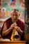 Tibetan Buddhist monk playing religios music intstrument during prayer in Thiksey gompa (Buddhist monastery)