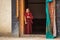 Tibetan buddhist monk watching mask festival from Lamayuru monastery door in Ladakh, India