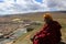 A Tibetan monk overlooking the Yarchen Gar Yaqen Orgyan Temple