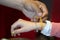 Tibetan monk while putting bracelet on buddihst hand