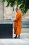 Tibetan monk taking a picture of fountain on a place