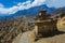 Tibetan prayer stupa or prayers place of the faithful Buddhists in center Mountains Path. Blue Sky Background