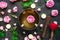 Tibetan singing bowl with floating rose inside. Burning candles, tea rose flowers and petals on the black stone background. Medita