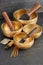 Tibetan singing bowls with palo santo, white sage and aroma sticks on the dark background. Music instruments for meditation, yoga