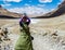 Tibetan woman commits bark around Mount Kailash.