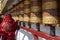 Tibetan woman turning prayer wheels in Lhasa, Tibet