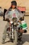 Tibetan worker driving a broken local Chinese motorbike in Tibet