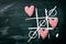 Tic Tac Toe Game. Love or Valentine`s Day Concept with Chalkboar