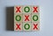 Tic-tac-toe, red X and green zero symbols on wooden cubes on a white background. Business marketing strategy planning