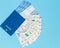 Tickets for airplanes and passport, Ukrainian hryvnia on a blue background. Copy space for text