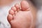 Tickle them...I dare you. an unrecognisable babys adorable feet at home.