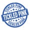TICKLED PINK text written on blue round stamp sign