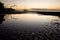 Tidal Flat and Sailboat at Sunset