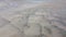Tidal sandy plains on the Atlantic Ocean. Wet beach sand, top view. Seaside landscape, drone video