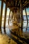 Tide coming in under pier at sunset