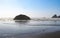 Tide lapping at the shore with huge rocks jutting out of the ocean