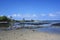 Tide pools, sandy shoreline, palm trees and volcanic rock at low tide at Kaloko-Honokohau National Historical Park in Hawaii