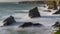 Tide rushes over rocks near the Bedruthian Steps, Cornwall