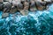 Tidewater Green sea or ocean water with foam at tropical stone coastline as trendy design background