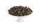 Tie Guan Yin Oolong tea on white porcelain container