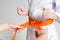 Tie orange karate belt for student, martial arts lesson for kids