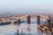 Tied arch bridge across winter river during construction, Kyiv, Ukraine