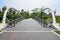 Tied arch bridge with asphalted roadway over water in city of sunny summer morning