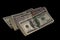 Tied bundles of 100 USD bills on black