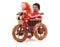 Tied dolls on toy bike.