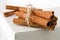 Tied dried cinnamon sticks on white board on table - selective focus