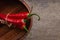 Tied red chili peppers on old wooden table