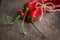 Tied red chili peppers on old wooden table